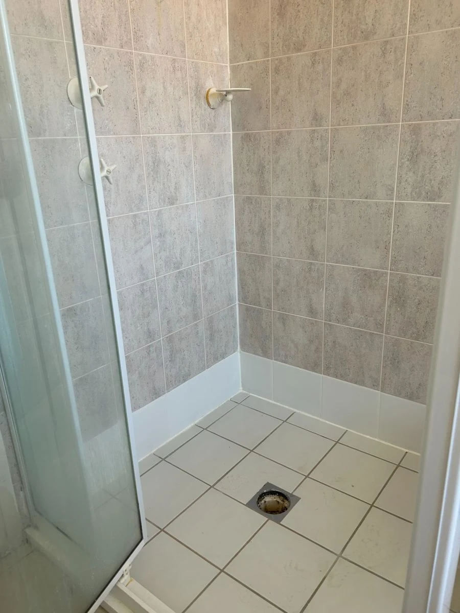 Freshly grouted grey shower